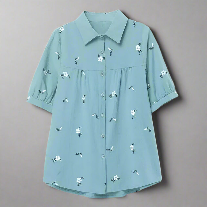 Light blue shirt with floral patterns on a white background
